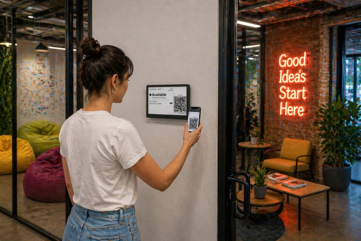 Person tapping a QR code on a Lobby e-ink display beside a meeting room door